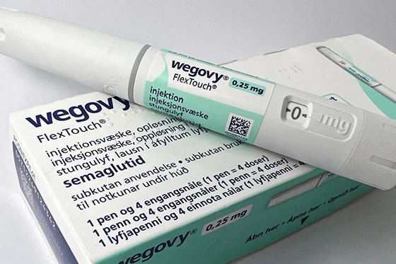 Wegovy 0.25 mg FlexTouch injection pen placed on top of its packaging box.